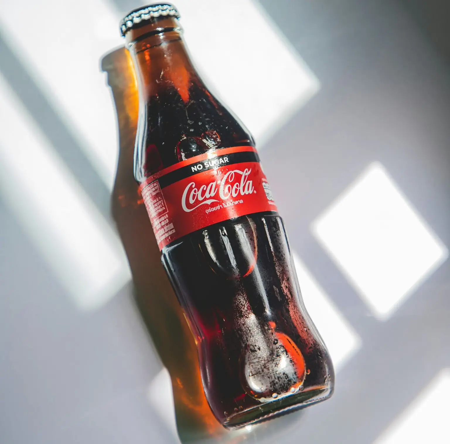 coca cola bottle on white table